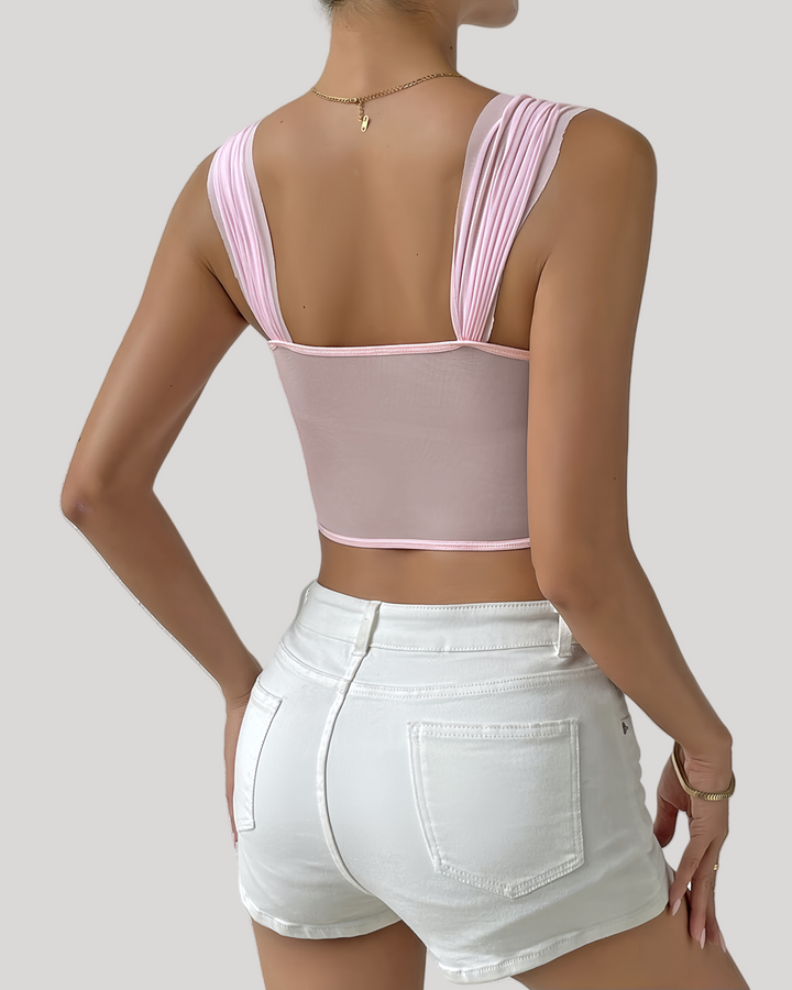 Back view of pink 3D floral rosette bustier top showing sheer mesh panel and wide pleated straps
