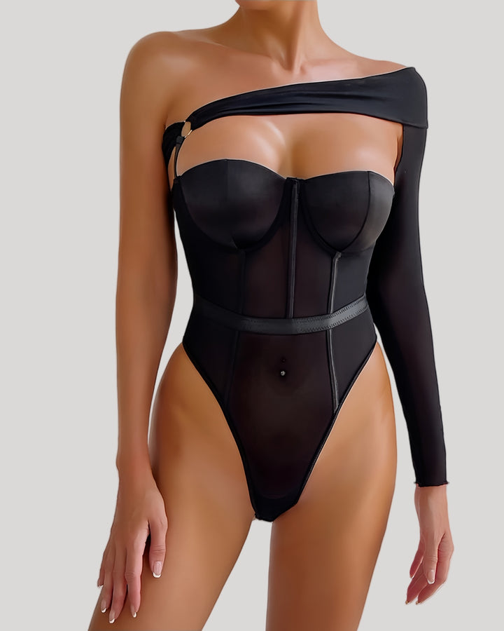 Front view of model wearing one-shoulder sheer black mesh teddy