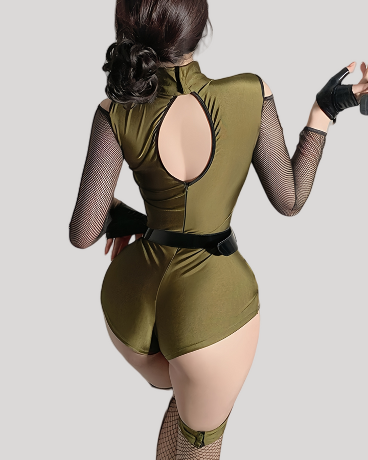 Person wearing a green bodysuit with a high slit on a light gray background