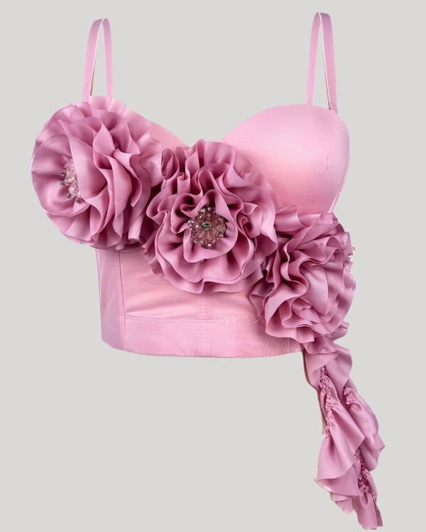 Front view of pink rosette corset top with cascading floral drape