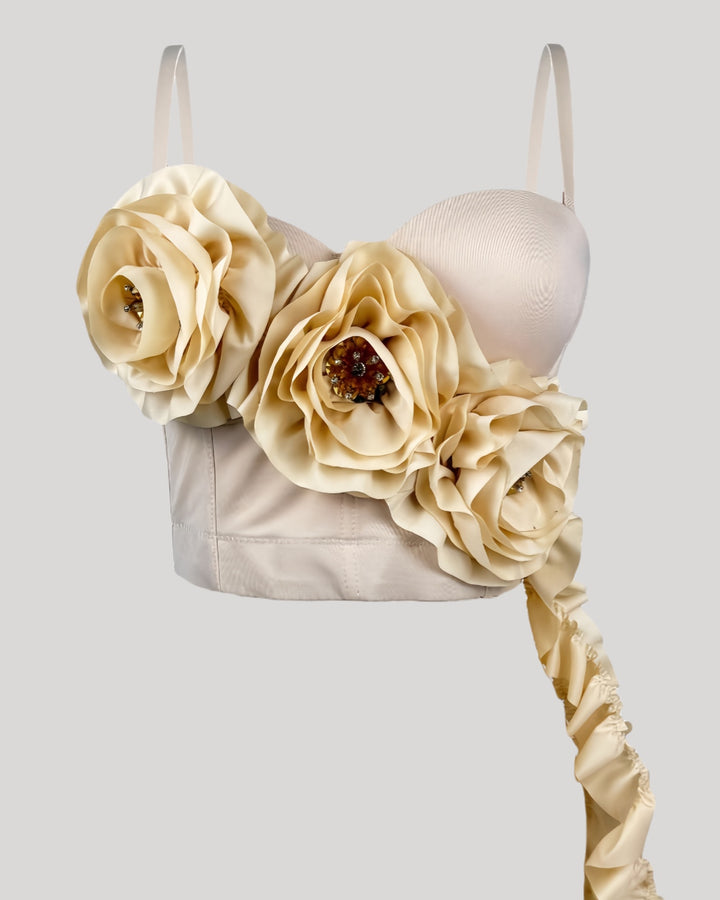 Front view of cream corset top featuring oversized rosettes