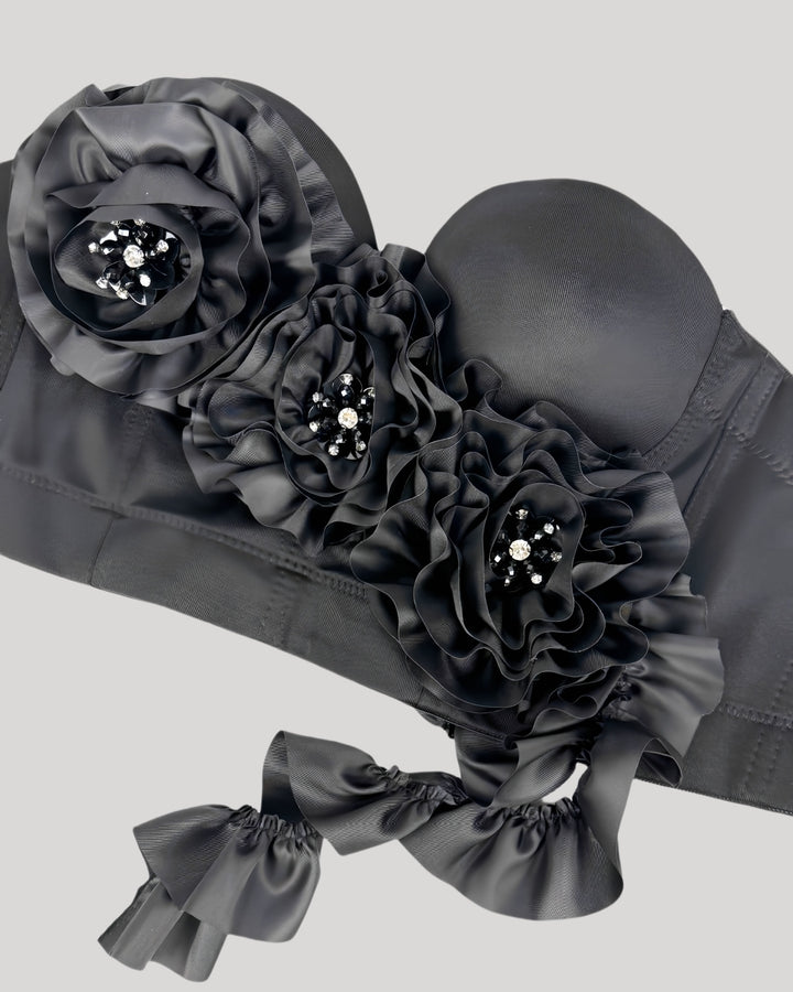 Front view of black corset top with jeweled floral accents