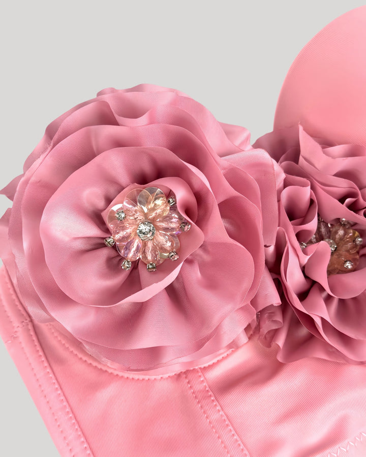 Close-up of pink rosette showing crystal-like jeweled center