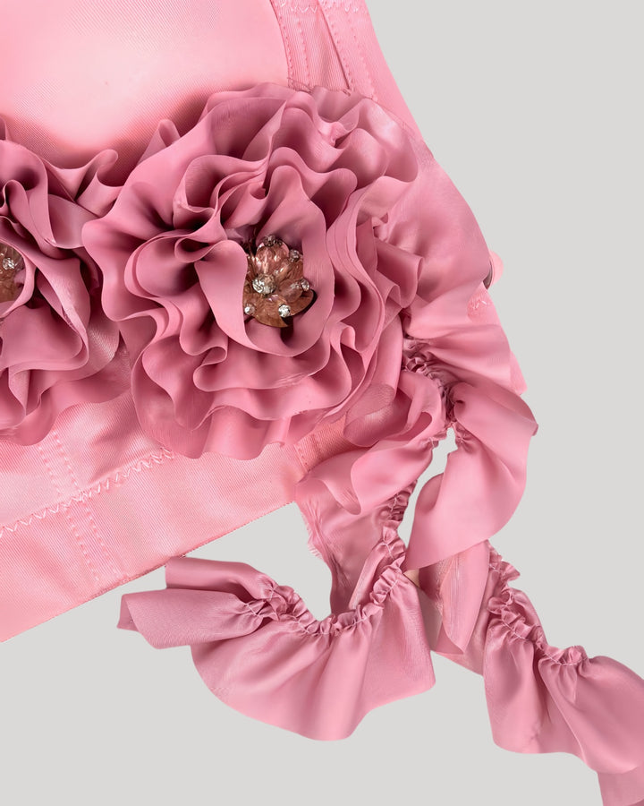 Close-up of pink rosette showing crystal-like jeweled center