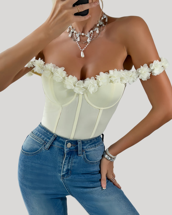 Front view of off-shoulder ivory bodysuit with floral neckline