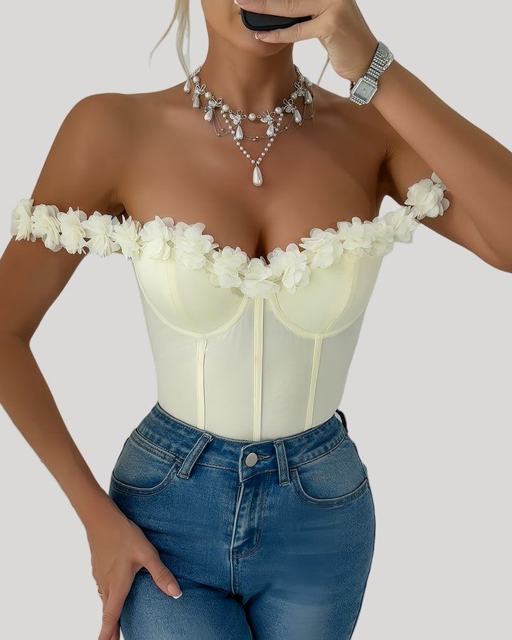 Front view of off-shoulder ivory bodysuit with floral neckline
