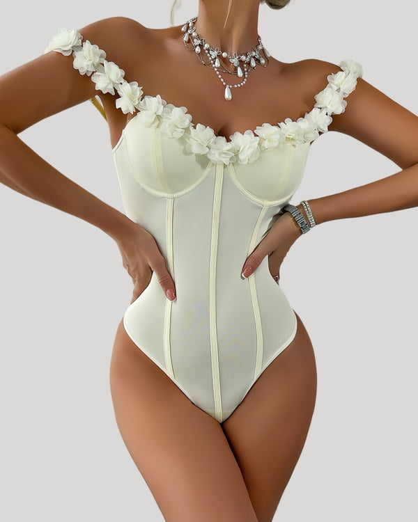 Front view of off-shoulder ivory bodysuit with floral neckline