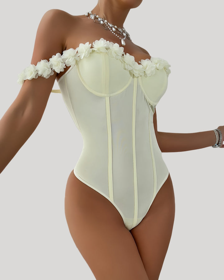 Front view of off-shoulder ivory bodysuit with floral neckline