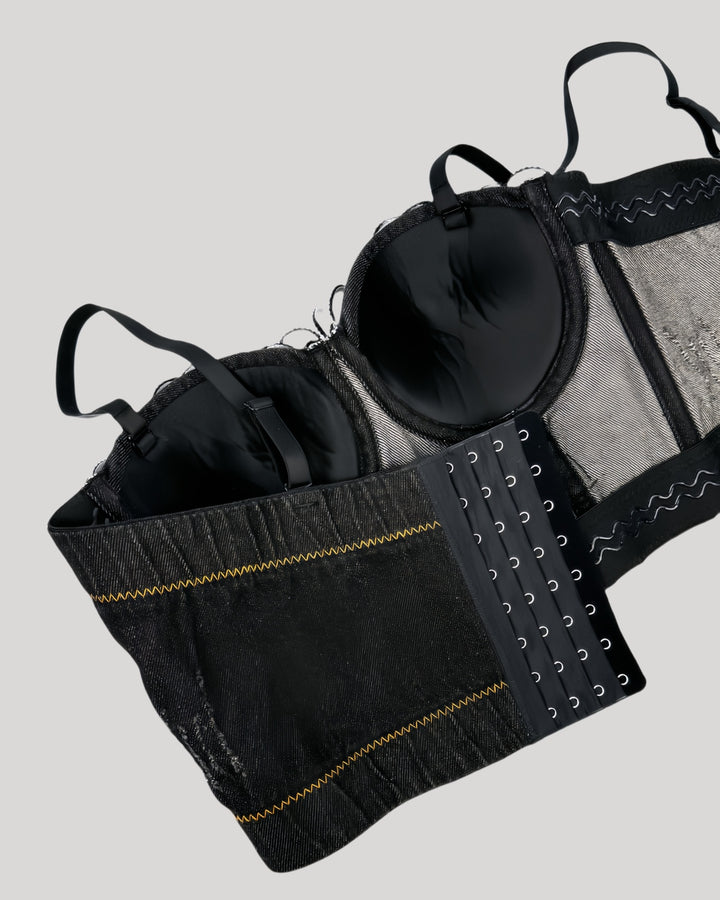 Back view of black denim corset with floral trim and stitching