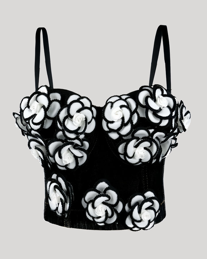 Front view of black denim corset with white floral appliqués