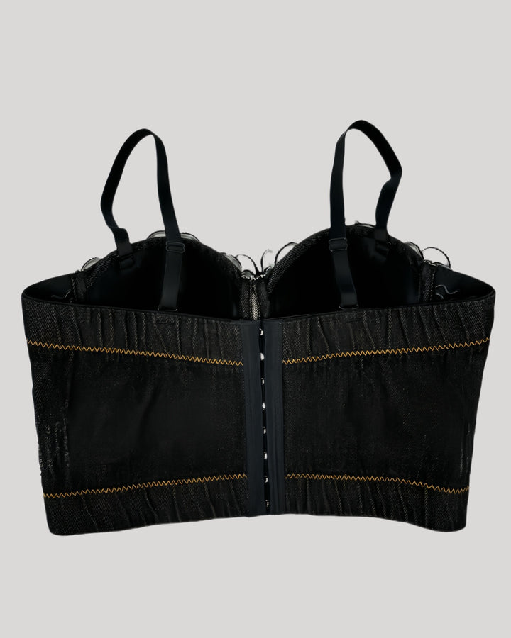 Back view of black denim corset with floral trim and stitching