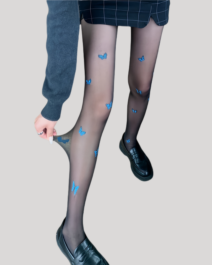 Black sheer tights with blue butterfly prints styled with loafers