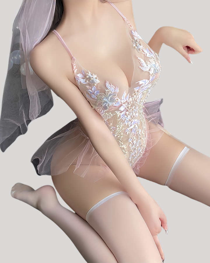 Side kneeling pose highlighting floral embroidery and tulle hips