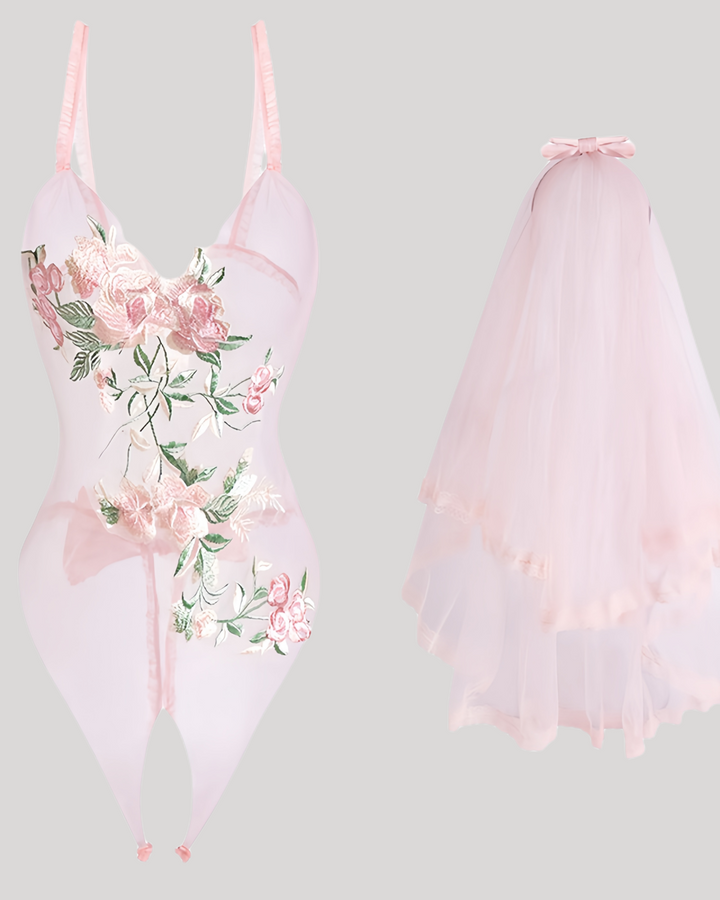 Close-up product shot of embroidered teddy and pink lace veil