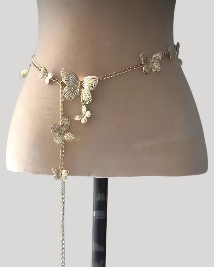 Gold butterfly waist chain with dangling charm on nude mannequin
