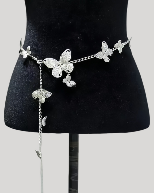 Silver butterfly waist chain with dangling charm on black mannequin