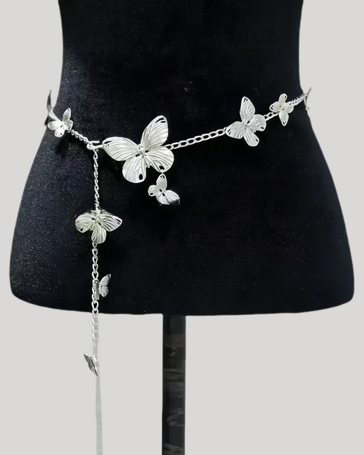 Silver butterfly waist chain with dangling charm on black mannequin