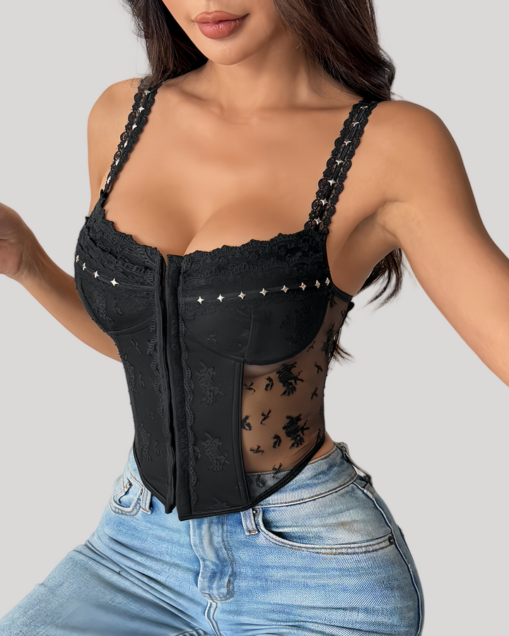 Model in black embroidered bustier with denim jeans, standing pose