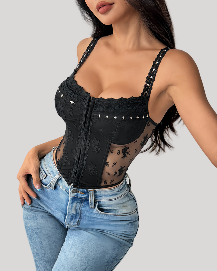 Model in black embroidered bustier with denim jeans, standing pose