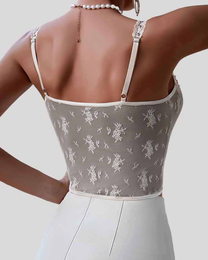 Back view of the mesh panel and adjustable straps in white lace bustier
