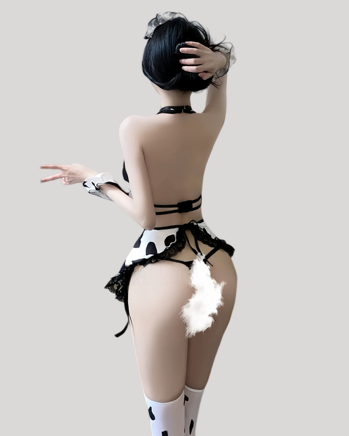 Back view showing low scoop back, cut-out sides, and lace-trimmed apron.