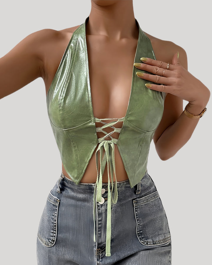 Model wearing green faux leather halter bustier with lace-up front