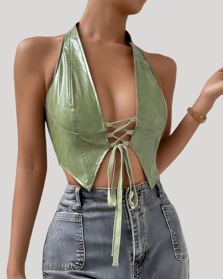 Model wearing green faux leather halter bustier with lace-up front