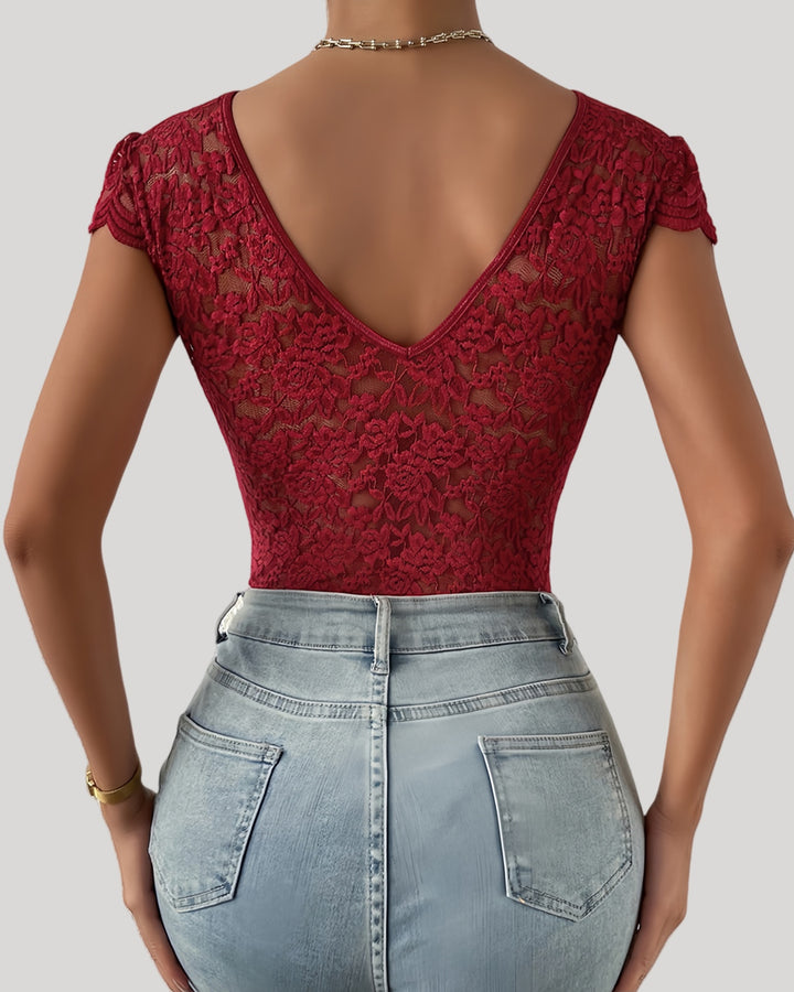 Back view of red lace bodysuit showing sheer floral pattern and deep V