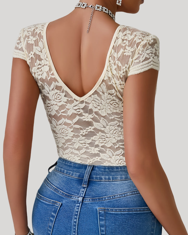 Back view of beige lace bodysuit showing sheer floral pattern and deep V