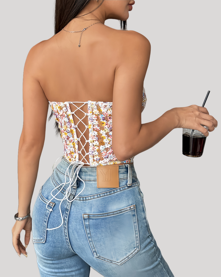 Back lace-up detail of floral corset with jeans