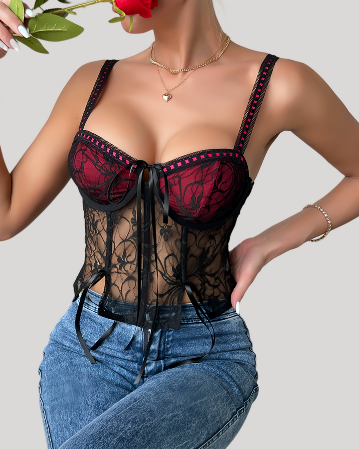 Close-up of black floral lace underwire bustier top with red underlay showing cups and ribbon detail