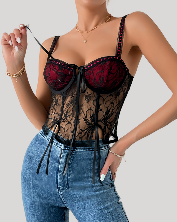 Black floral lace underwire bustier top with red underlay front view on model pulling ribbon