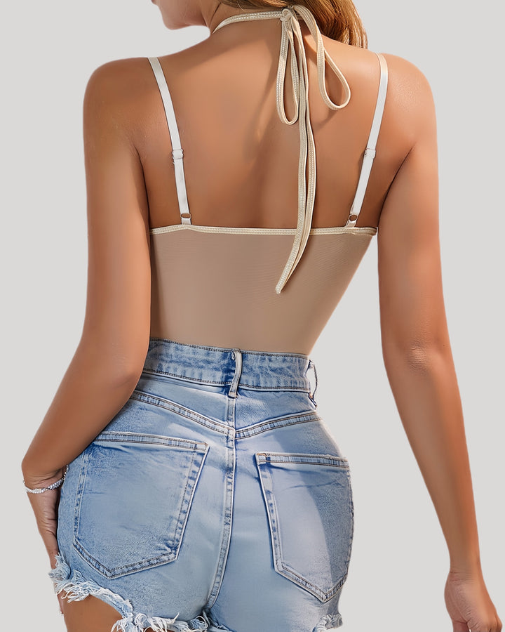 Back view of beige bodysuit with denim shorts