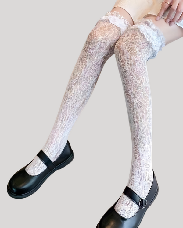 Floral jacquard thigh-high socks with ruffle top worn with black Mary Jane shoes and white skirt