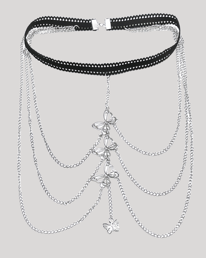 Detailed view of silver butterfly charms on thigh jewelry