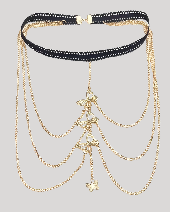 Detailed view of golden butterfly charms on thigh jewelry