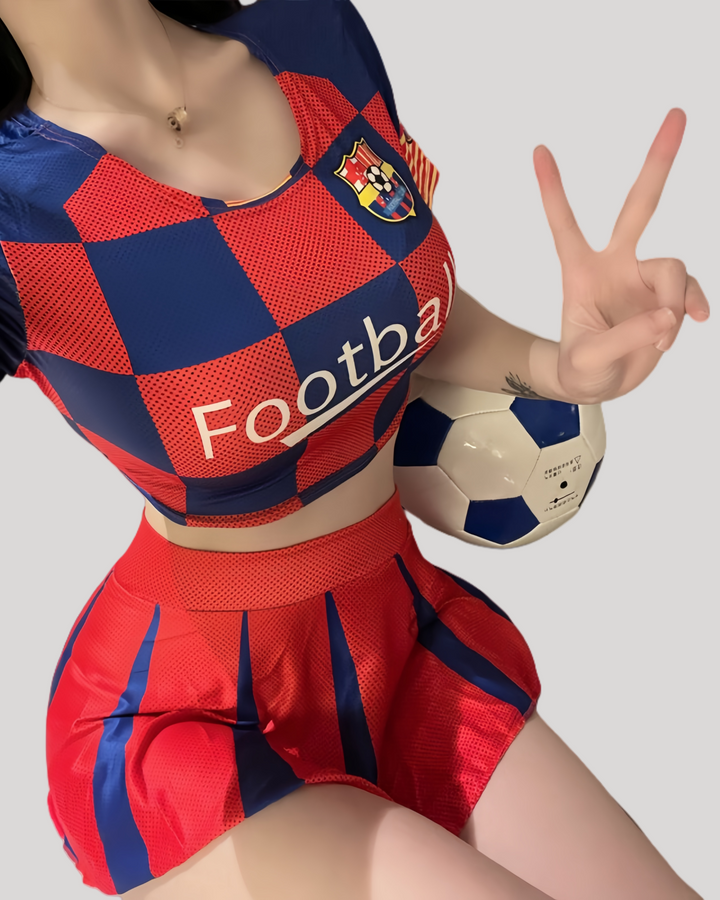 Model wearing red and blue football-themed crop top and pleated mini skirt