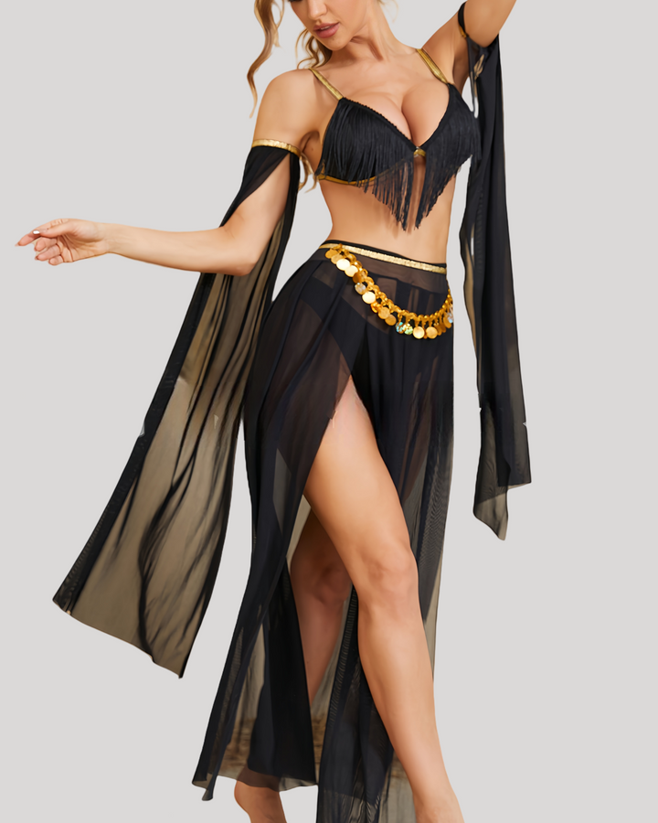 Side profile of mannequin in black belly dance costume showing lace-up side straps, fringed bra top, and long sheer skirt drape.