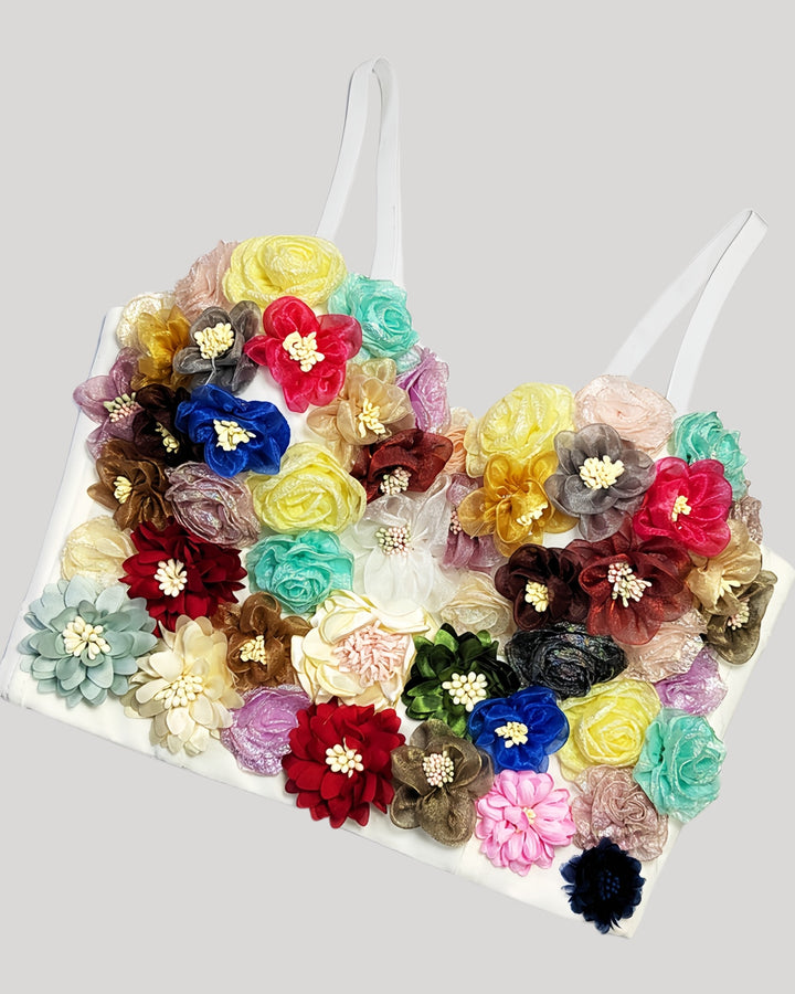 White corset featuring uniquely arranged handmade fabric flowers