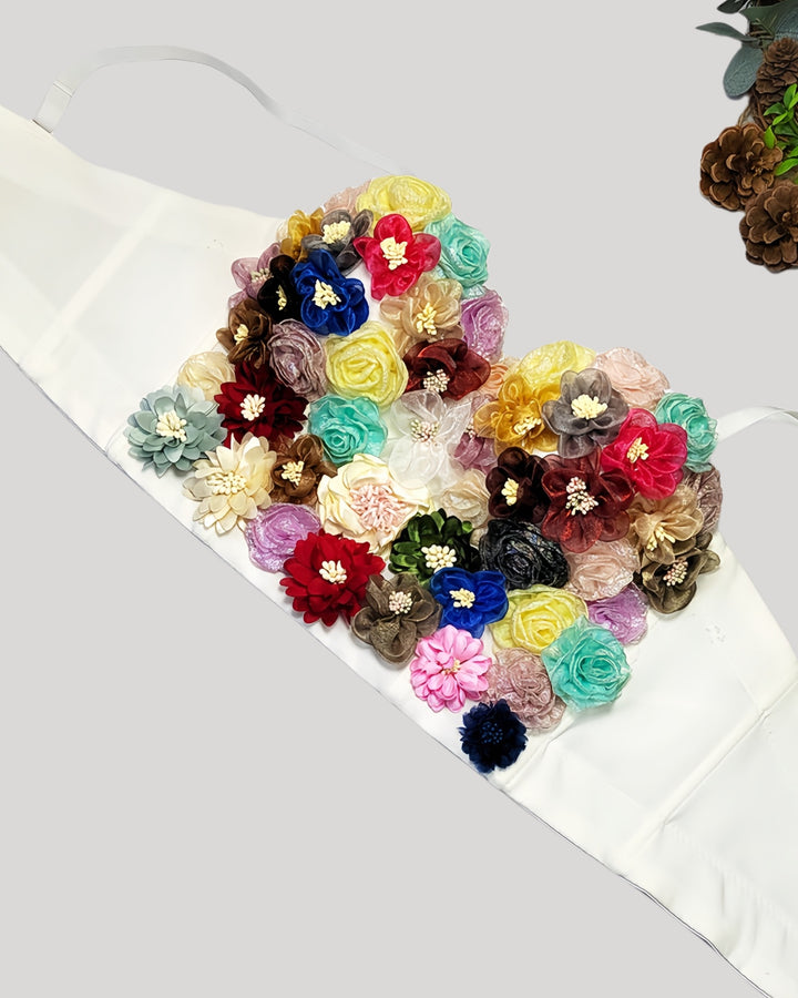 White corset featuring uniquely arranged handmade fabric flowers