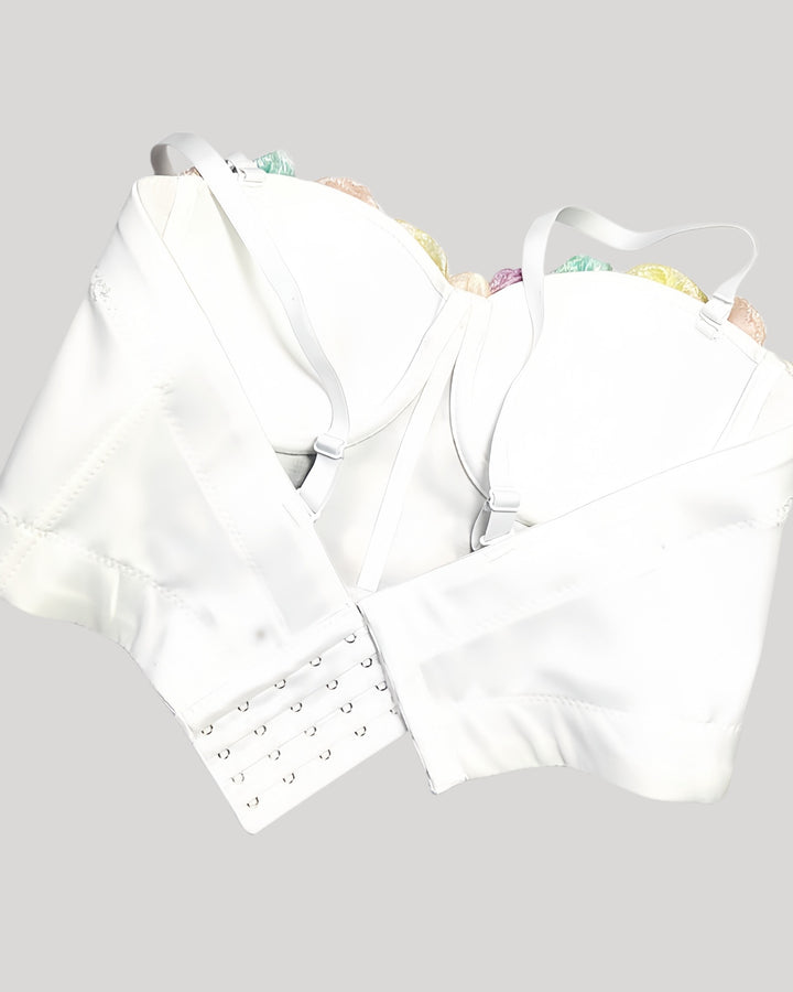 Back of white corset with adjustable straps and hook-and-eye closure