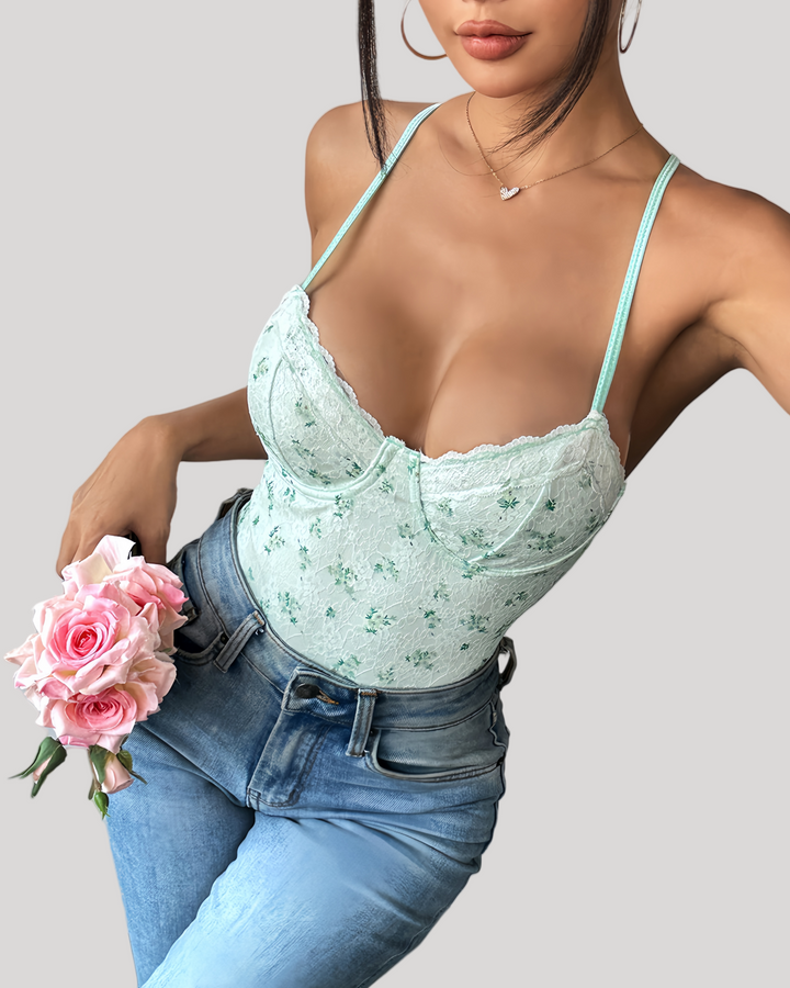 Front pose in green floral bodysuit showing delicate floral pattern