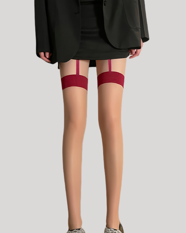 Model wearing sheer nude stockings with bold red bands and faux garter straps