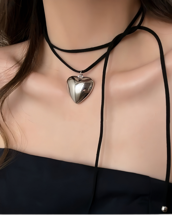 Silver heart pendant velvet wrap choker on model with black strapless top