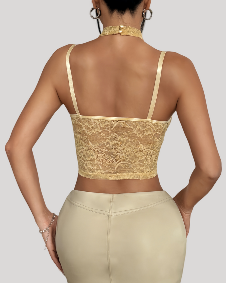 Back view of beige lace bustier showing semi-transparent lace and hook-and-eye closure