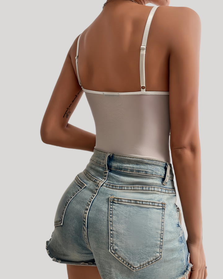 White lace corset bodysuit on model, back view against white wall
