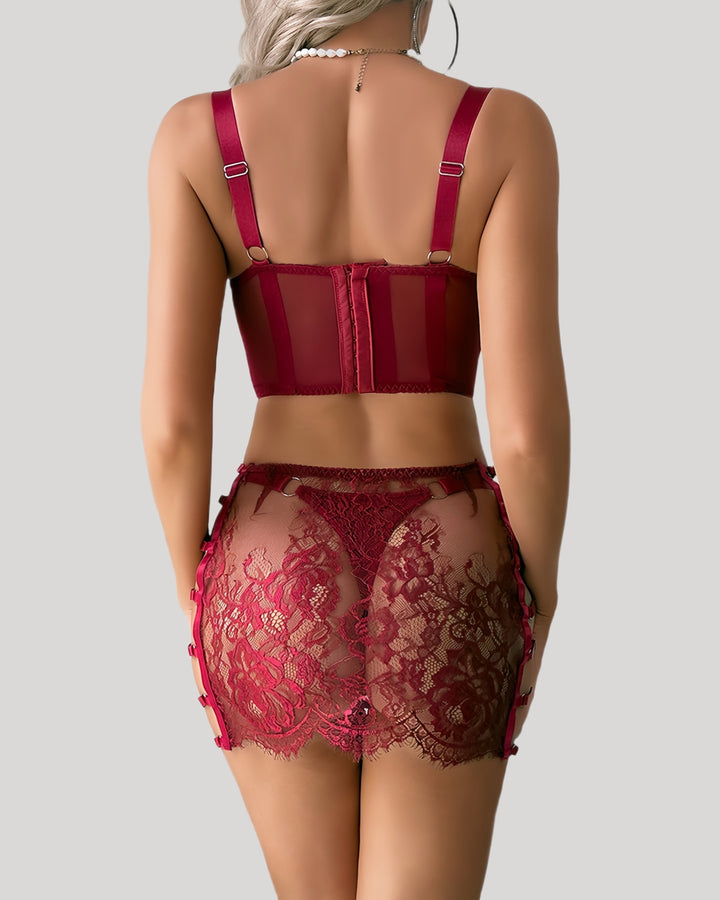 Back view of red lace skirt and bra set showing sheer floral lace detail