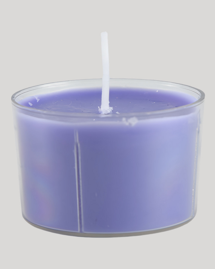 Purple low-temperature sensual play candle in a clear cup