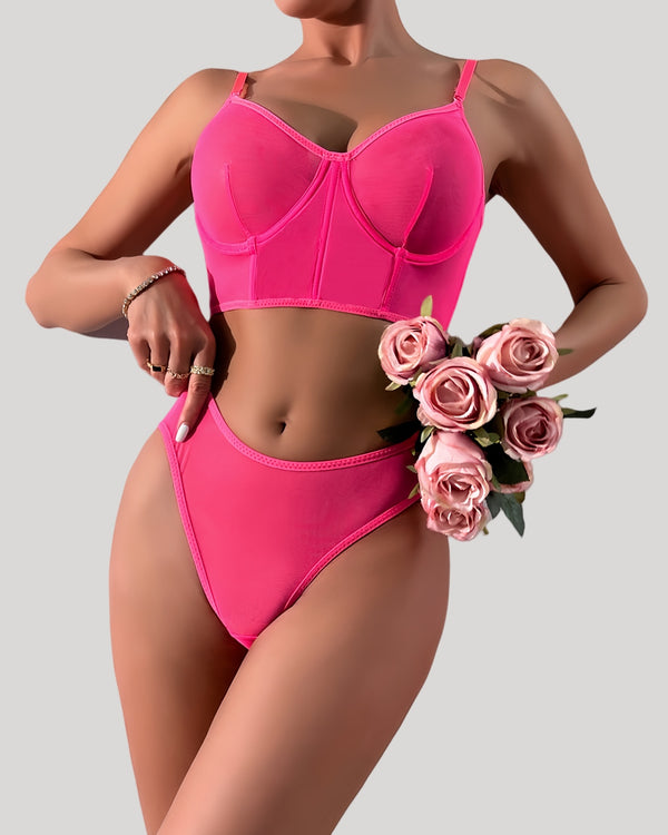 Front view of neon pink sheer mesh lingerie set on model
