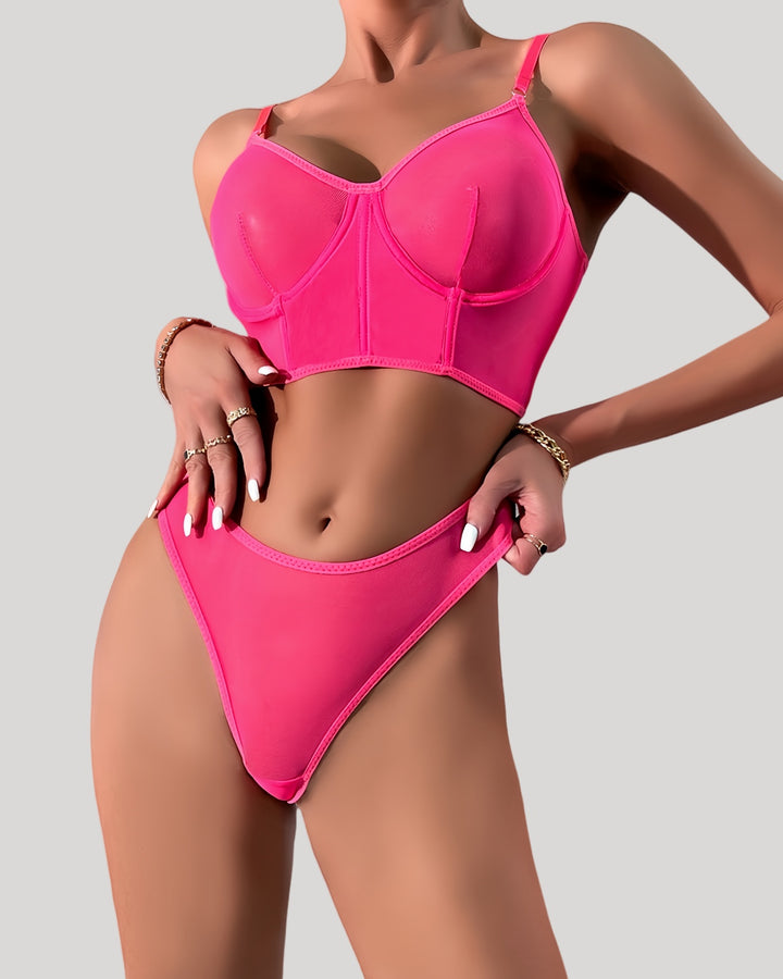 Front view of neon pink sheer mesh lingerie set on model